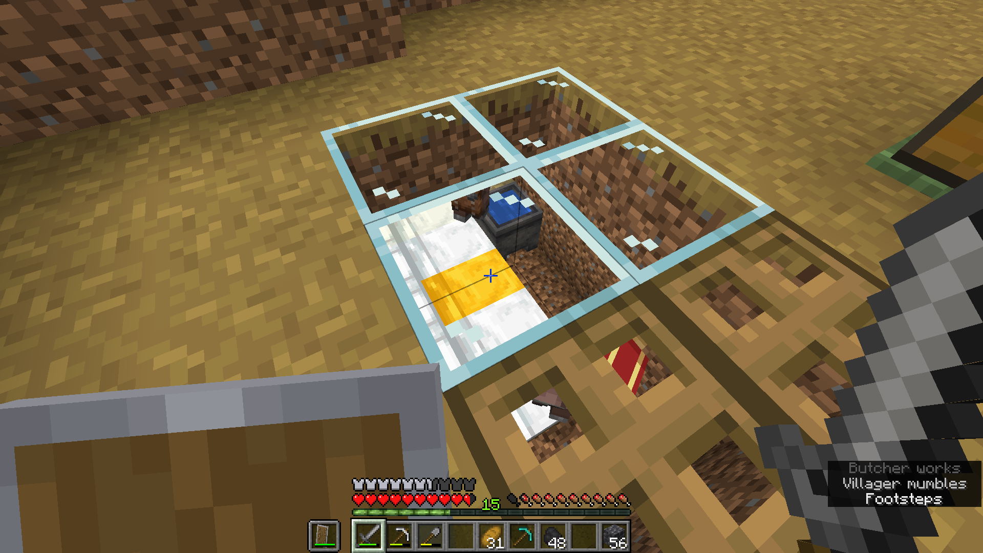 Image of ditch with villagers inside of it.